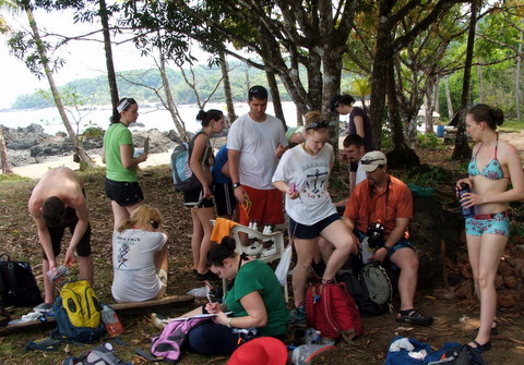 group of people around microscope